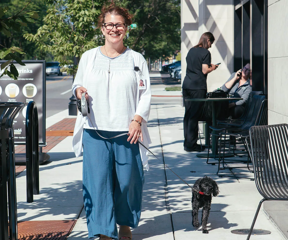 Concierge walking a dog at The Pearl