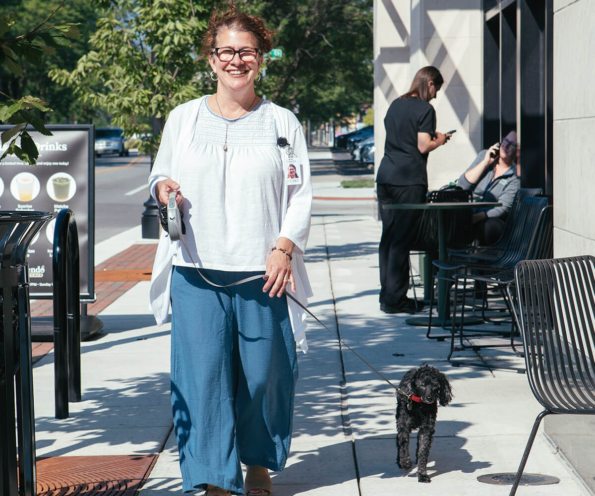 Concierge walking a dog at The Pearl