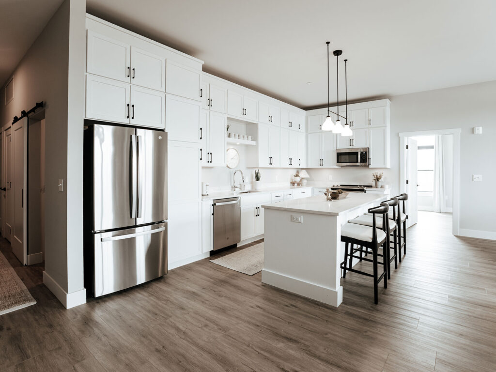 Designer Pearl kitchen and dining nook with stainless appliances and tile backsplash near downtown Fort Wayne