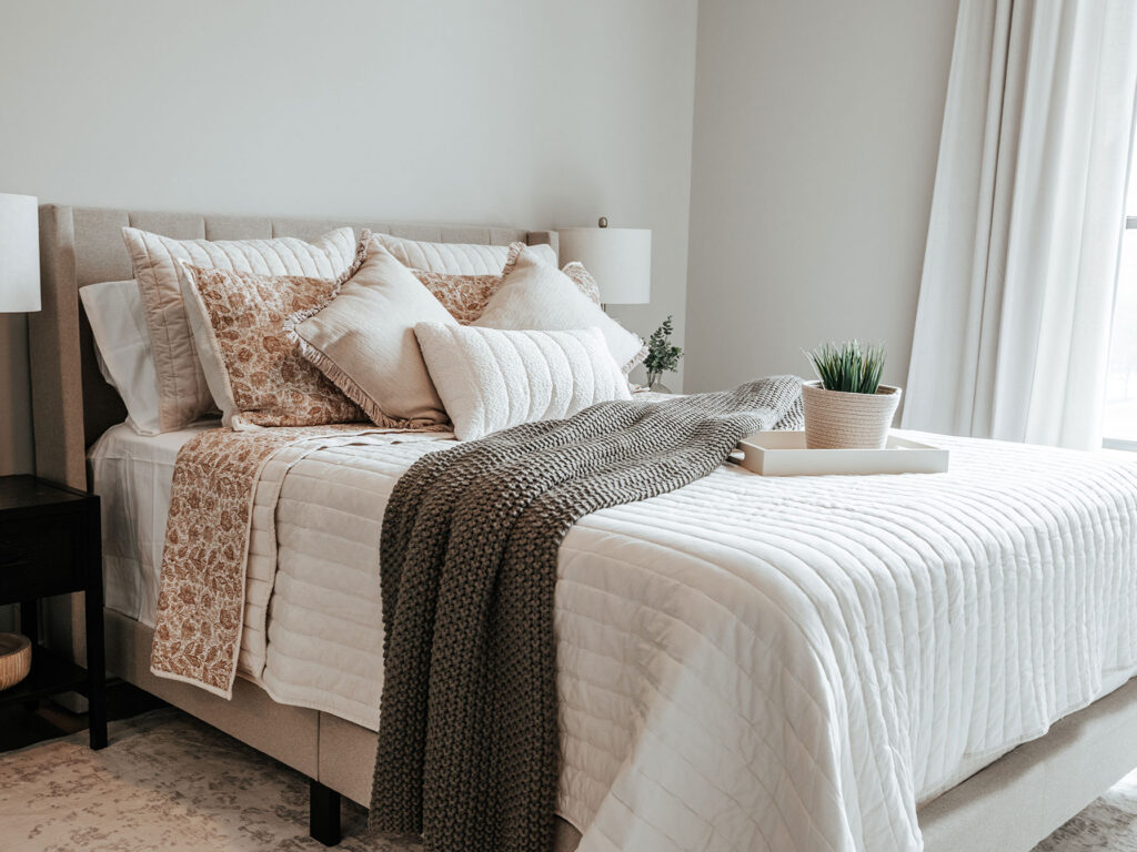 Primary bedroom suite at The Pearl with natural light and modern flooring in a Fort Wayne apartment home