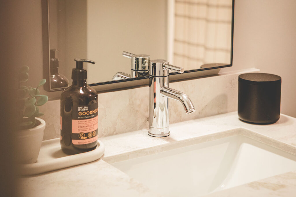 Sleek Pearl bathroom with tile shower, modern fixtures, and storage in a downtown Fort Wayne apartment