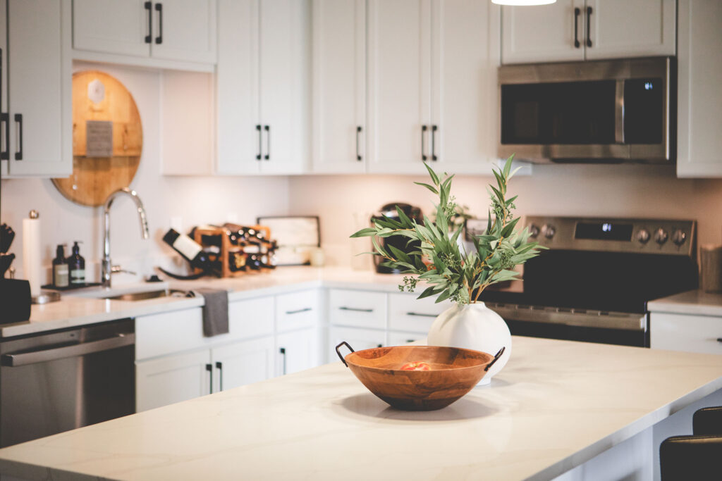 Modern Pearl kitchen with quartz countertops, stainless steel appliances, and designer cabinetry in Fort Wayne