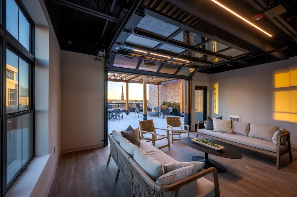 Rooftop terrace at The Pearl with lounge seating and city views in downtown Fort Wayne