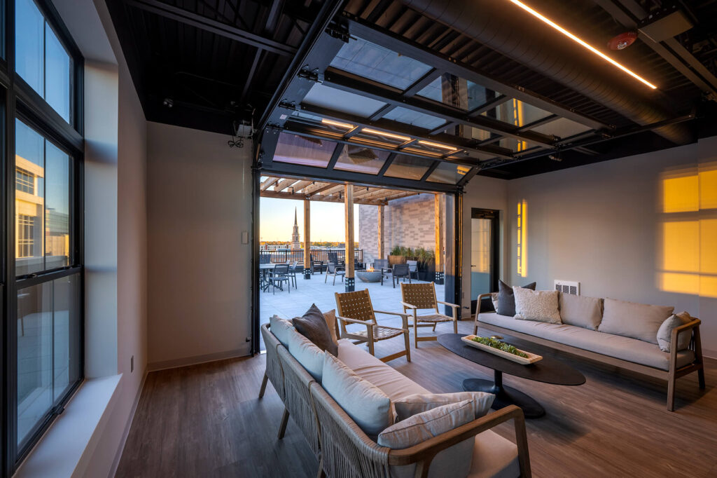 Rooftop terrace at The Pearl with lounge seating and city views in downtown Fort Wayne