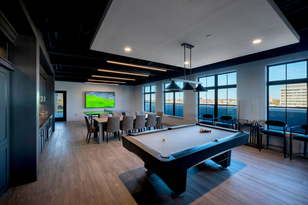 Resident game room at The Pearl with lounge seating and entertainment options